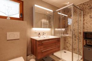 a bathroom with a sink and a shower at Chalet Belle Poncke by Jolidi in Nendaz +15 photos