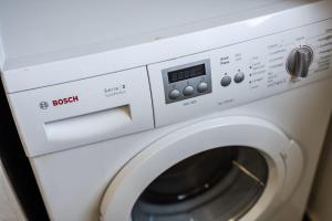 a white microwave oven with a washing machine at Maserati House - H24 in Modena
