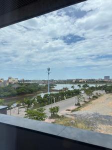 a view of a river from a window at Thuỳ Dung 68 Hotel in Dong Hoi