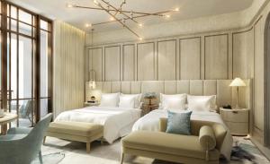a bedroom with a large white bed and a couch at The Theodore Hanoi in Hanoi