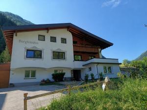 a house in the mountains with a fence at Haus Bergfrieden in Kaunertal