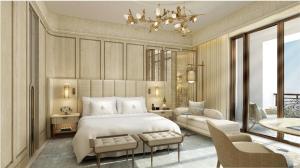 a bedroom with a bed and a living room at The Theodore Hanoi in Hanoi