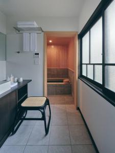 a small kitchen with a chair and a sink at KAZENO Kurayoshi in Kurayoshi