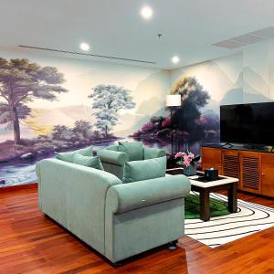a living room with a couch and a flat screen tv at Koulen Central Premier Suites in Siem Reap