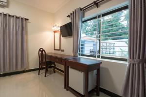 a desk in a room with a window at Raksmey Angkor Boutique in Siem Reap