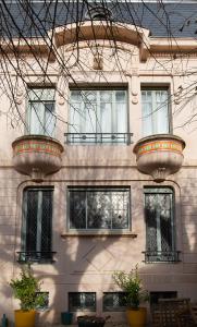 a building with two large pots on the side of it at Le Passagran in Boën