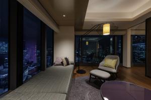a living room with a view of a city at night at THE BLOSSOM HIBIYA in Tokyo +102 photos
