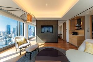 a living room with a view of a city at THE BLOSSOM HIBIYA in Tokyo