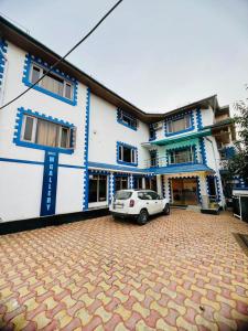 a white car parked in front of a building at MGallery in Srinagar
