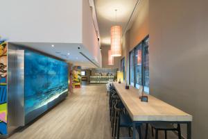 a restaurant with a large aquarium on the wall at Catalonia Avinyo in Barcelona