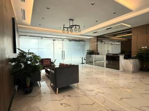 a lobby with a couch and a table in a building at Jtower residences mandaue 27flr in Mandaue City +6 photos