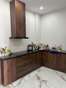 a kitchen with wooden cabinets and a counter top at Thuỳ Dung 68 Hotel in Dong Hoi