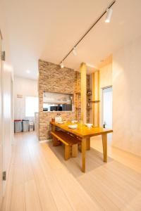 a kitchen and dining room with a wooden table at furano ski rabi in Furano