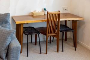 a wooden table with two chairs and a wooden table with a table at furano ski rabi in Furano