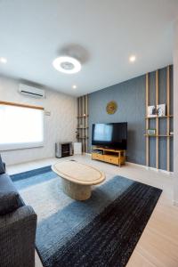 a living room with a couch and a coffee table at furano ski rabi in Furano