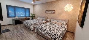 a bedroom with two beds and a couch and a window at Suites Only KKB in Kuala Kubu Bharu +18 photos