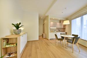a kitchen and dining room with a table and chairs at 555 SoleSun in Druskininkai