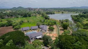 an aerial view of a house with a river at Cape Sigiriya in Sigiriya