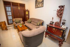 a living room with a couch and a table at Wenzel Villa in Hikkaduwa
