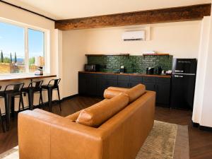 a living room with a couch and a kitchen at The Wesley Boutique Hotel Page, AZ in Page