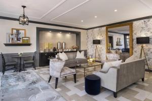a living room with a couch and a table at The Carolina Inn, a Destination by Hyatt Hotel in Chapel Hill