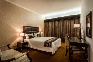 Postel nebo postele na pokoji v ubytování Hotel Vip Grand Maputo