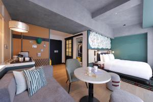 a hotel room with a bed and a table at Caption by Hyatt Namba Osaka in Osaka