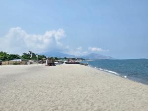 a beach with a group of boats on the water at Villa España in San Narciso