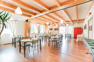 a restaurant with wooden ceilings and tables and chairs at Affitta camere LUNAR in Borgo +13 photos