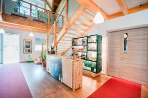 a living room with a staircase and a red rug at Affitta camere LUNAR in Borgo