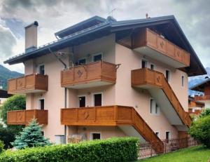 a building with wooden balconies on the side of it at Appartamento Daniela Dolomiti. in Auronzo di Cadore