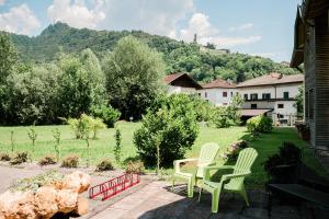 two chairs and a teddy bear sitting in a yard at Affitta camere LUNAR in Borgo