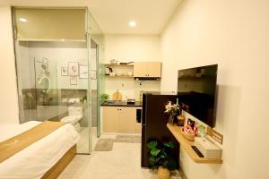 a bathroom with a shower and a toilet and a sink at Maison Boutique Hotel - Bình An in Phước Lộc Xã