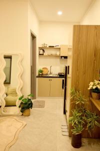 a living room with a kitchen with plants in it at Maison Boutique Hotel - Bình An in Phước Lộc Xã +69 photos