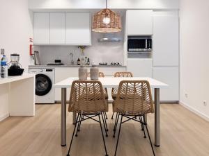 a kitchen with a white table and two chairs at Dani's House - Nazaré in Nazaré