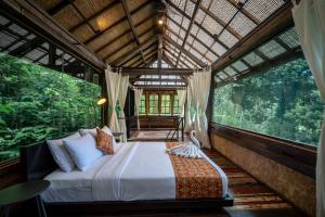 a bedroom in a tree house with a bed at Kalpa House Sidemen in Sidemen