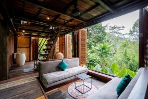 an outdoor living room with a couch and a table at Kalpa House Sidemen in Sidemen