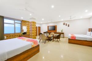 a hotel room with two beds and a television at Ginger Jammu , Bari Bramhana in Jammu +23 photos