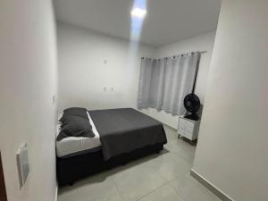 a bedroom with a bed in a white room at Beach Loft - Design e Estilo in Maricá +27 photos