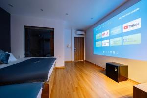 a room with a bed and a large screen at Minn Cat Ba in Cat Ba +21 photos