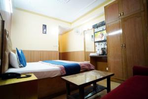 a hotel room with a bed and a table at Hotel King Palace in Shimla