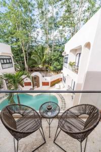 a balcony with two chairs and a table at Modern 1BR with Spacious Living Room in Uluwatu