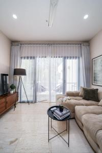 a living room with a couch and a table at Modern 1BR with Spacious Living Room in Uluwatu