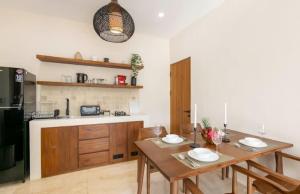 a kitchen with a wooden table and a dining room at Modern 1BR with Spacious Living Room in Uluwatu +60 photos