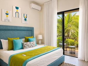 a bedroom with a bed and a sliding glass door at SALTA apartment l Complex Ocean terraces in Poste Lafayette +34 photos