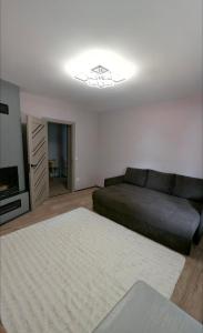 a living room with a couch and a television at Хата над гуком in Kosiv