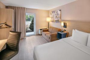 a hotel room with a bed and a chair at Comfort Inn Sydney - Cape Breton in Sydney +31 photos