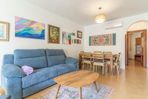 a living room with a blue couch and a table at Apartment Mountain View Torrox town in Torrox
