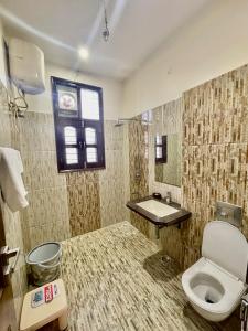 a bathroom with a toilet and a sink at ZenRoofs-3 BHK Bungalow in Jaipur +25 photos