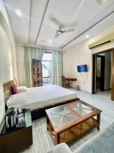 a bedroom with a bed and a glass table at ZenRoofs-3 BHK Bungalow in Jaipur
